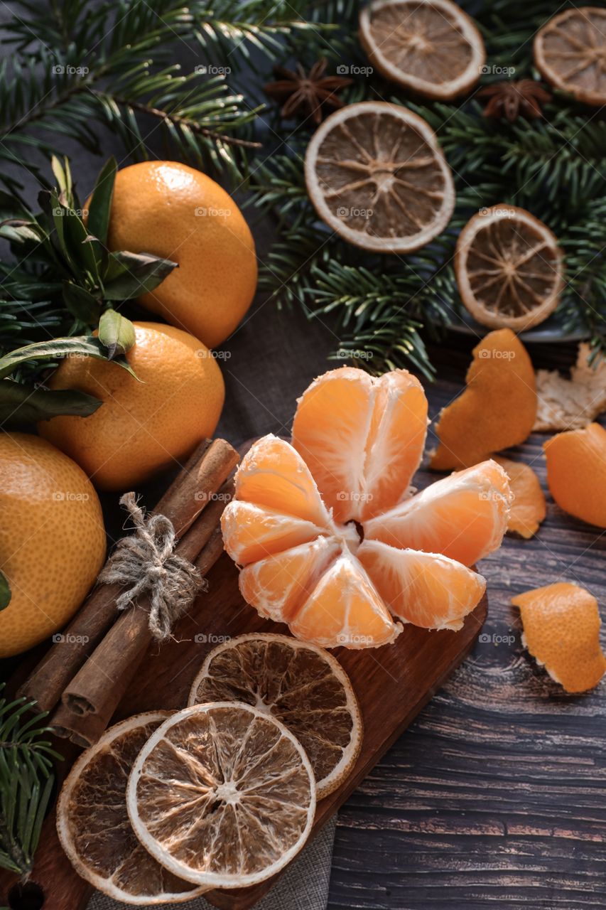 Flatlay mandarin orange cinnamon and Christmas tree branches 