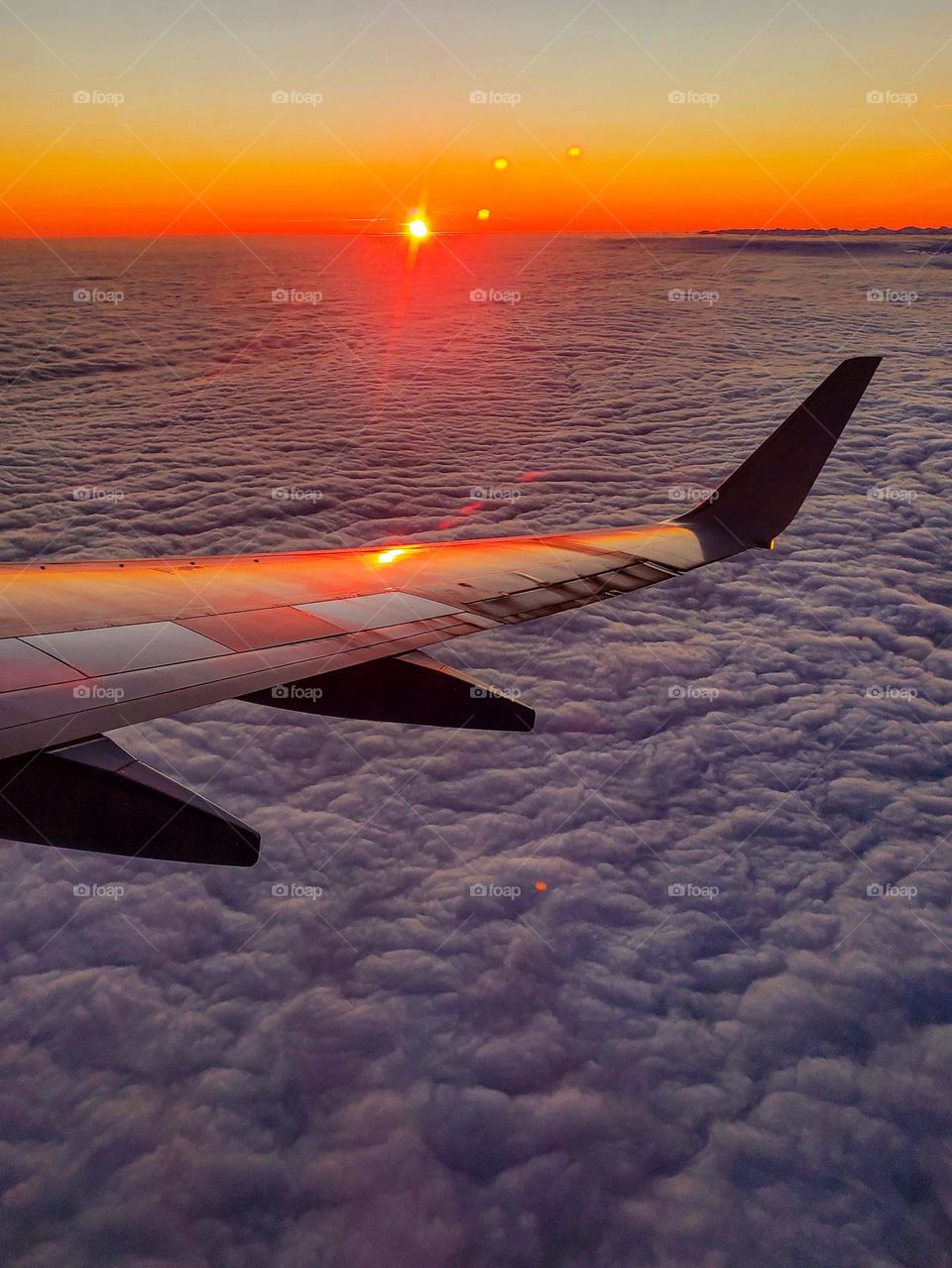 The sun sets over a low cloud bank somewhere over the state of Washington in the US