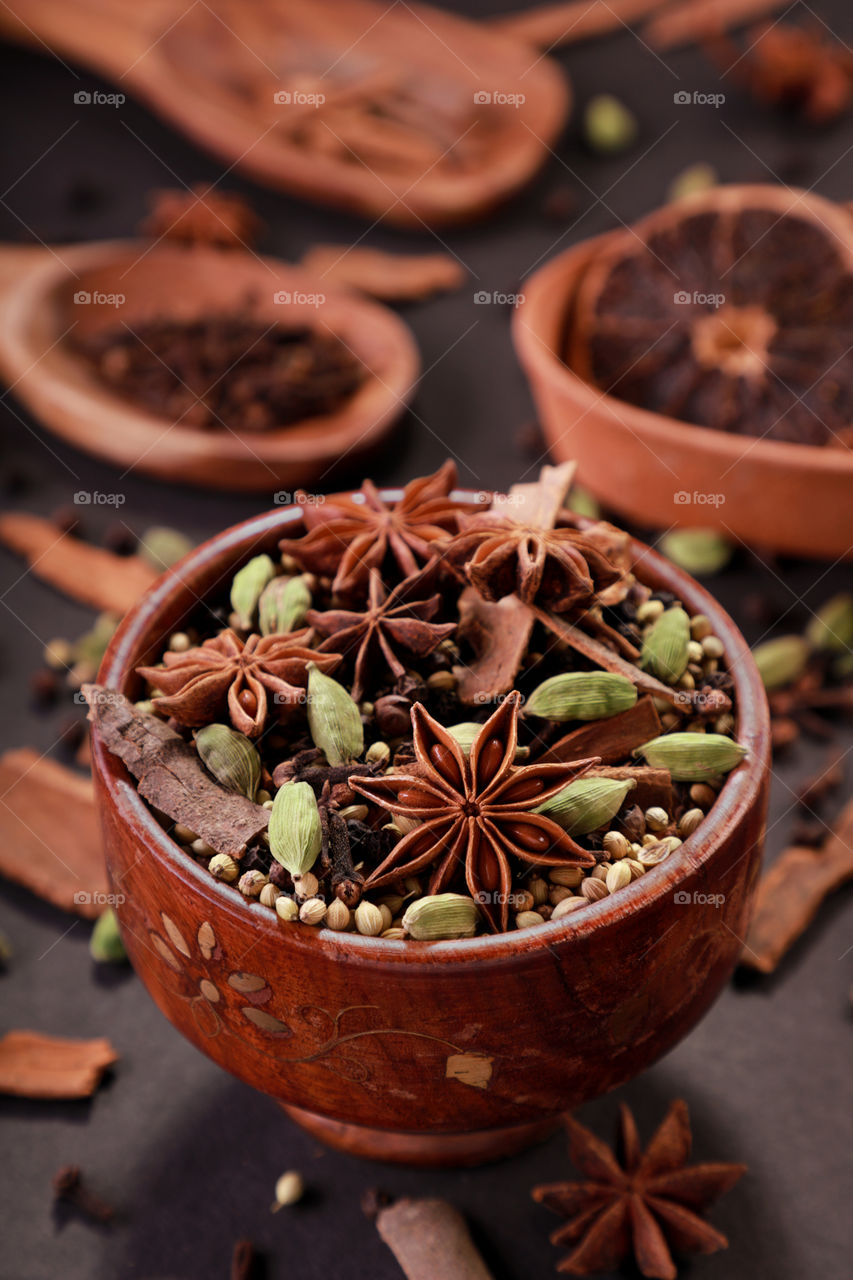 Indian spices and herbs in a wooden bowl