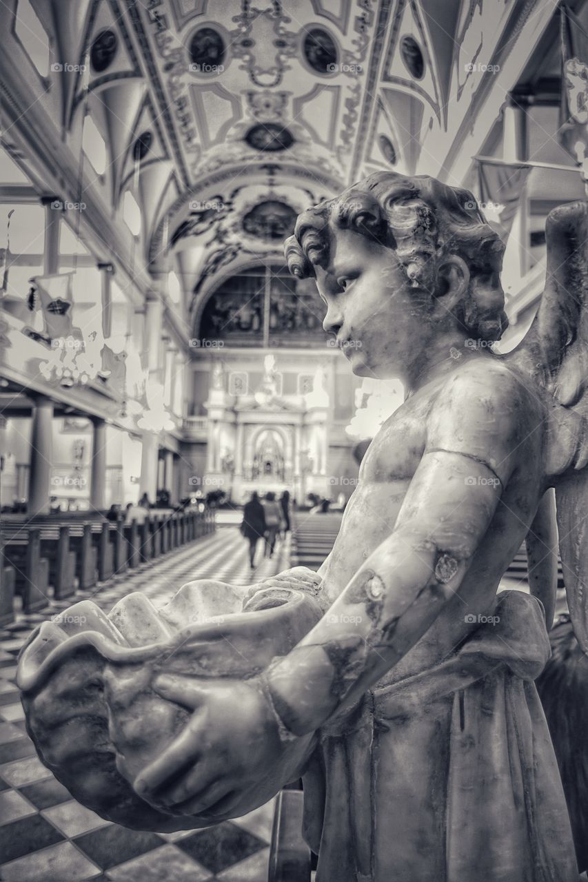 Statue of an angel inside St. Louis Cathedral at Jackson Square, French Quarter, New Orleans, Louisiana, USA. Monochrome image.