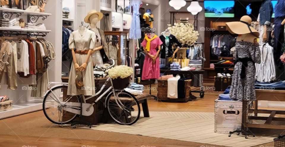 White bicycle and wooden mannequins in the mall