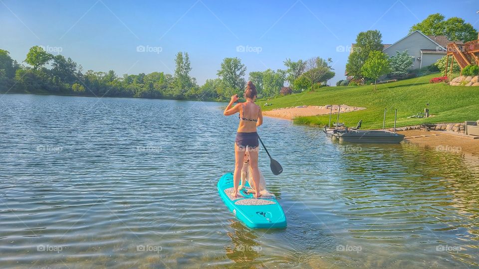 dog between her legs SUP