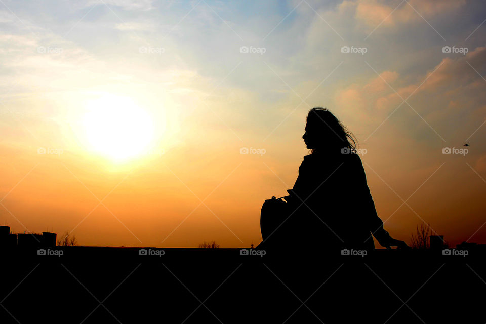 a sad girl under sunset