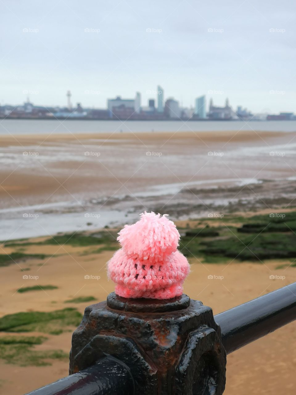 knitted hat on fence