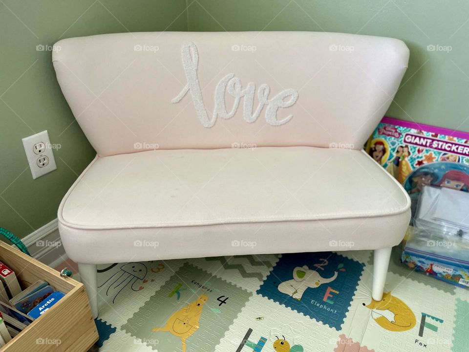 Child’s sofa in a playroom, toddler sofa with love written on it, pink children’s couch