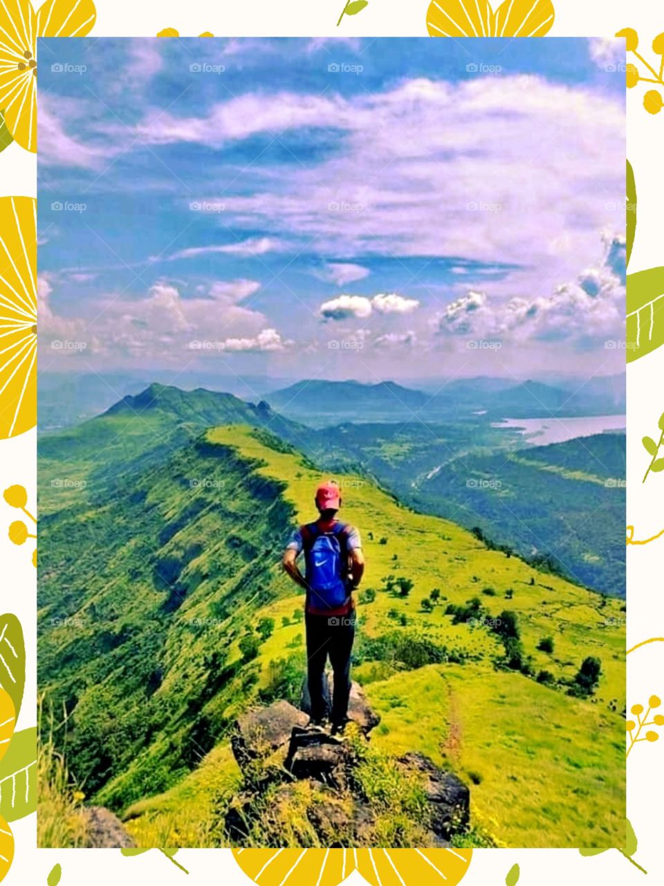 Mountain Climbing.
This gentle man is standing on the big rock while watching the beautiful scenery of nature.