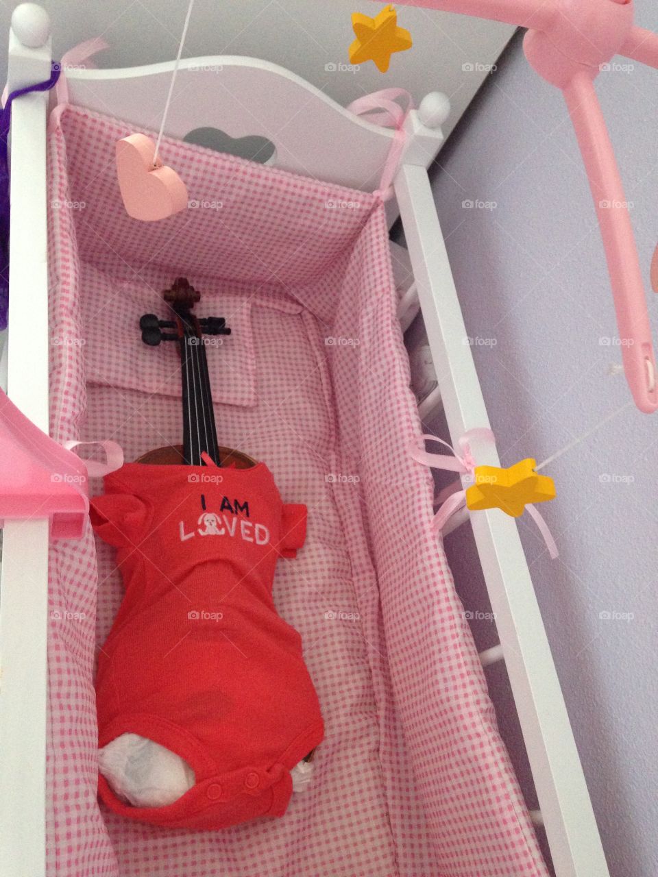 Much Loved Friend. This is how I found my six year old's cherished violin.  In her doll crib sporting a diaper and onesie!