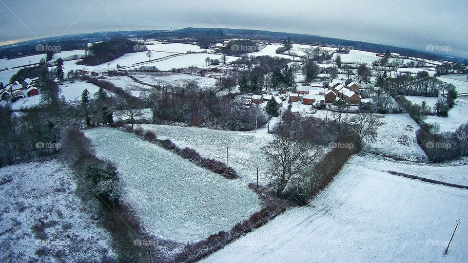 Drone image above a snowy, rural France.