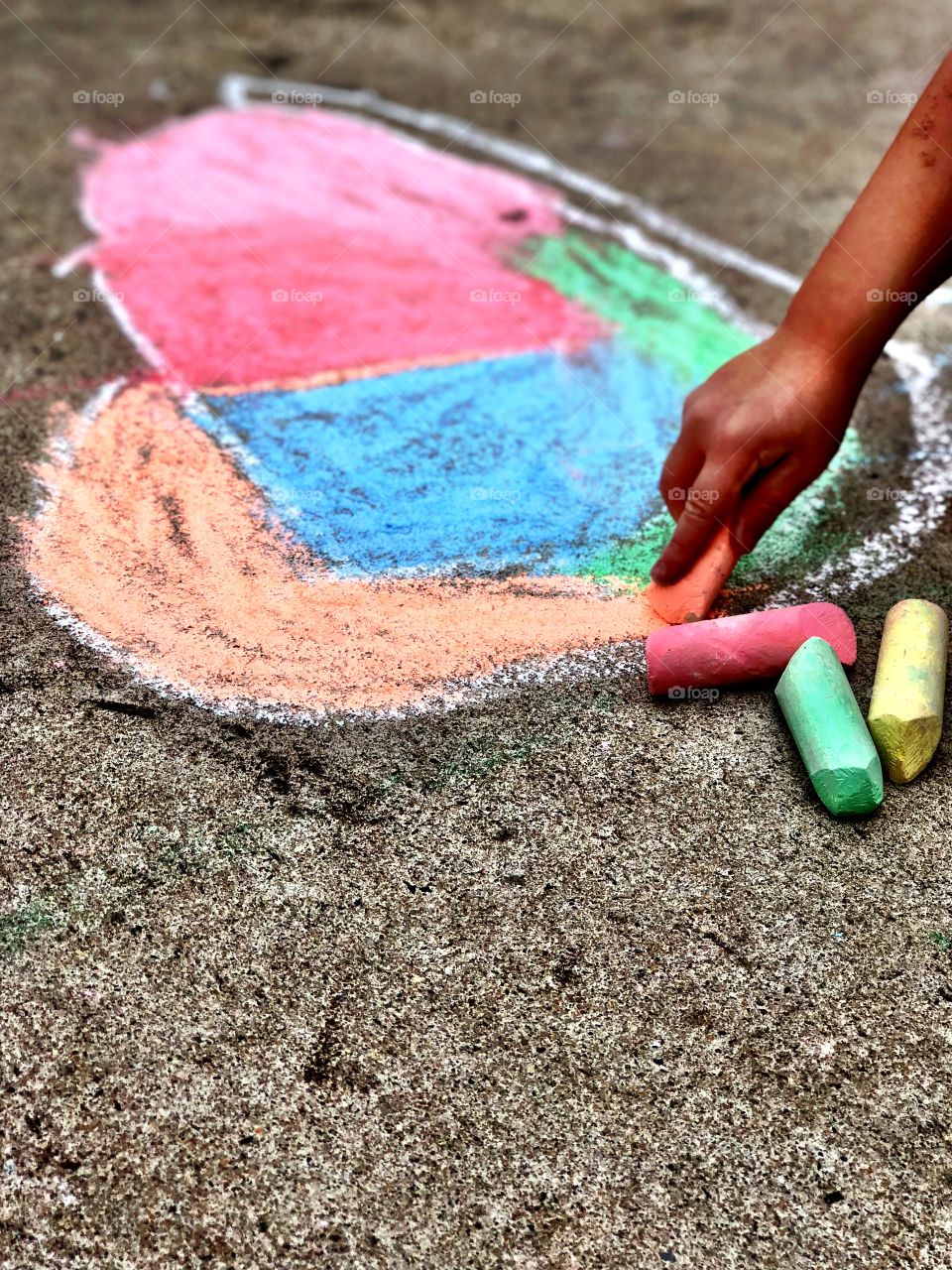 Child Drawing a Heart with Sidewalk Chalk 