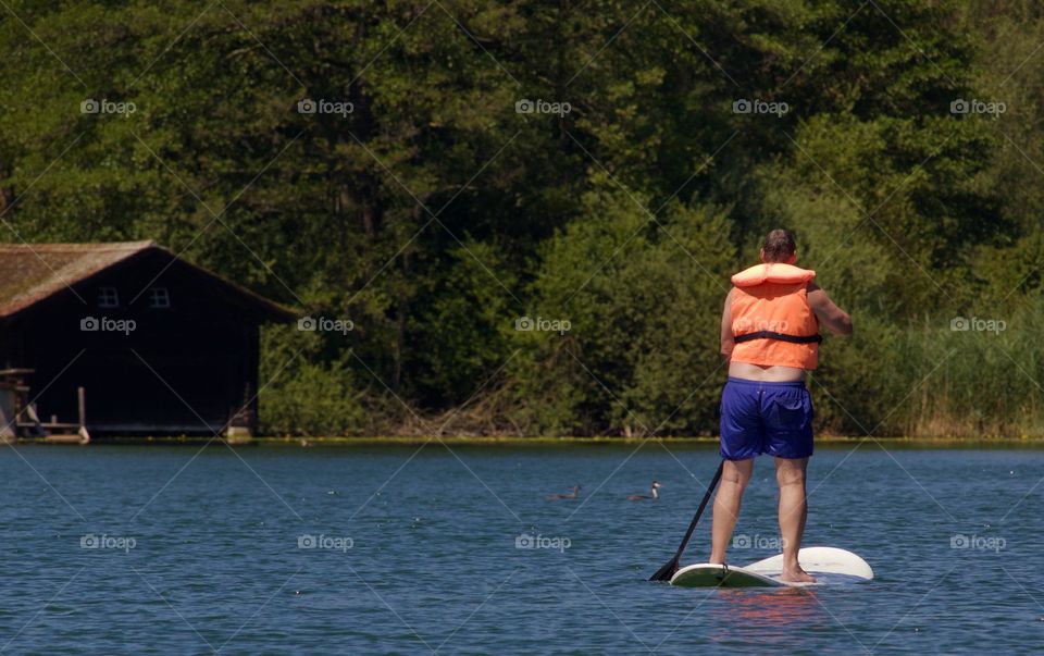 People Having Fun At Lake In Summer