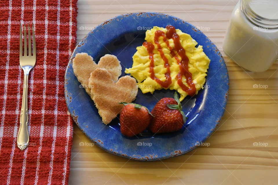 Scrambled eggs with toast and fruit