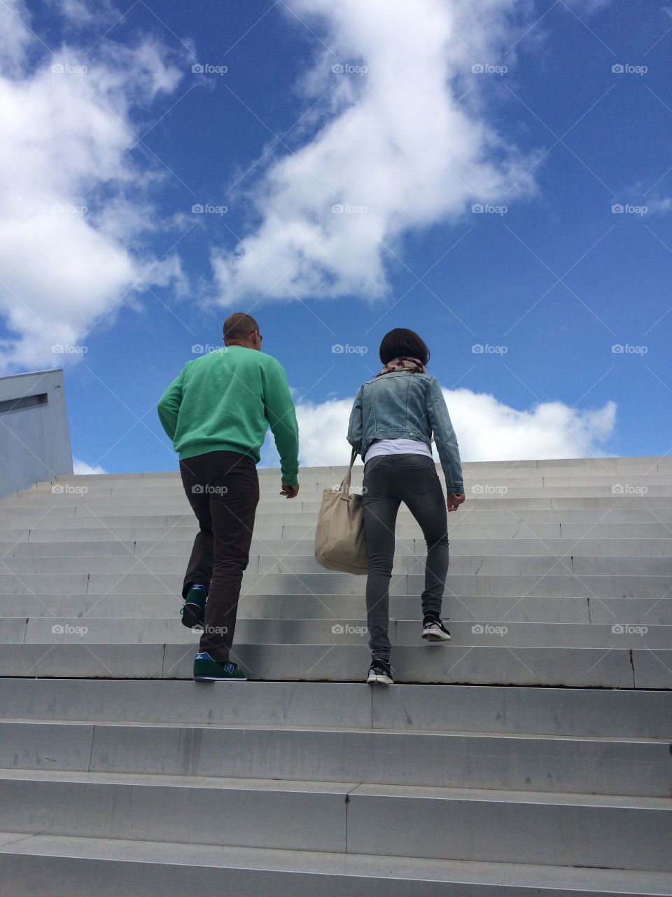 Staircase in the sky. Father and daughter ascending from museum below