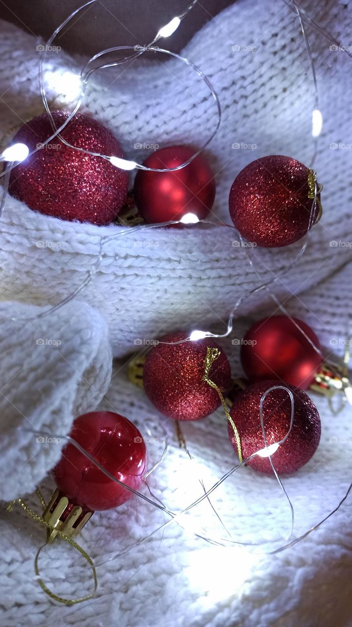 Red baubles on white blanket