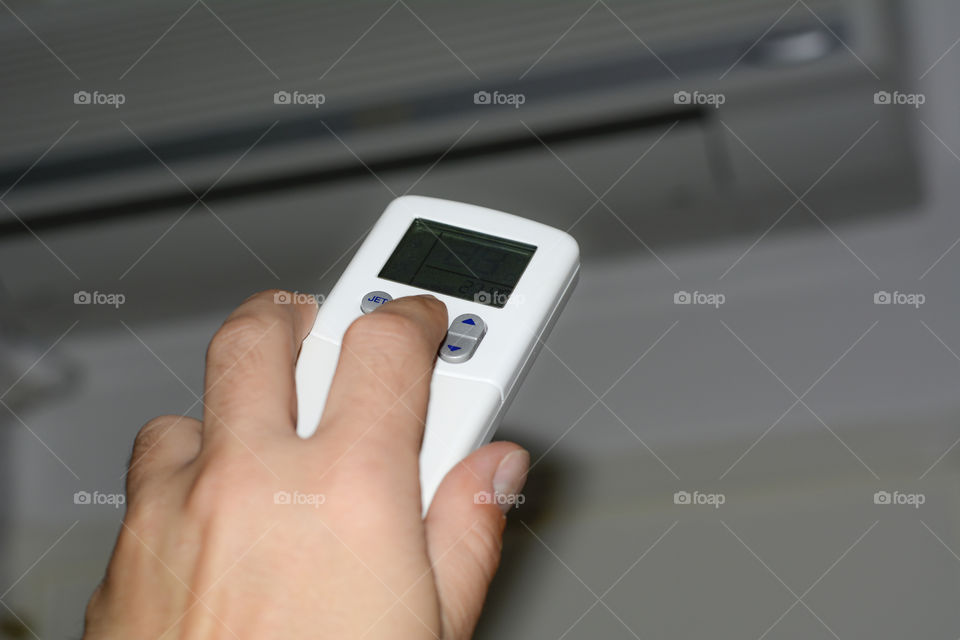 A/C Remote control in a hand