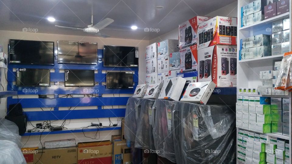 Led TVs and refrigerators are located in this electronics shop.