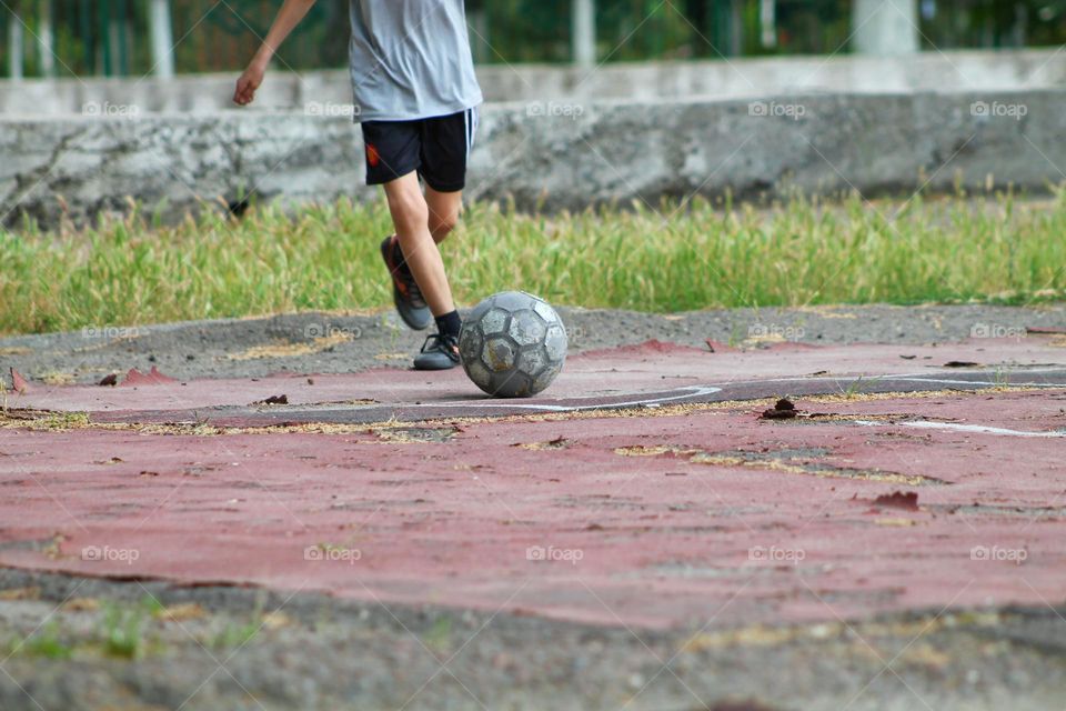 children in the old stadium playing football