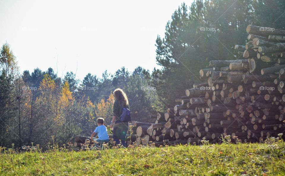 mother and son walking and riding on a bike beautiful nature landscape