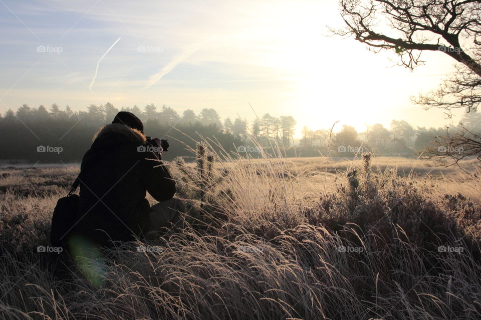 Golden hour photographer. My friend photographing the sun during golden hour, so I photographed him and it turned out very nice.