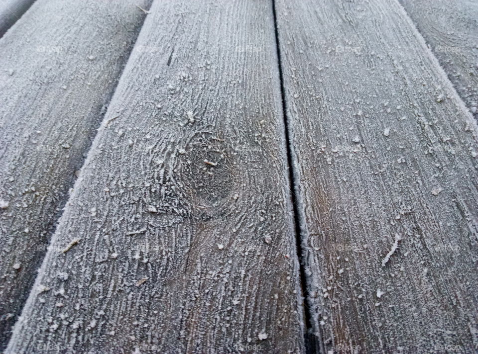 grey frozen wooden table in the garden