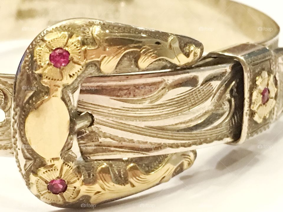 Silver, gold and ruby handmade bracelet designed to look like a belt and buckle. 