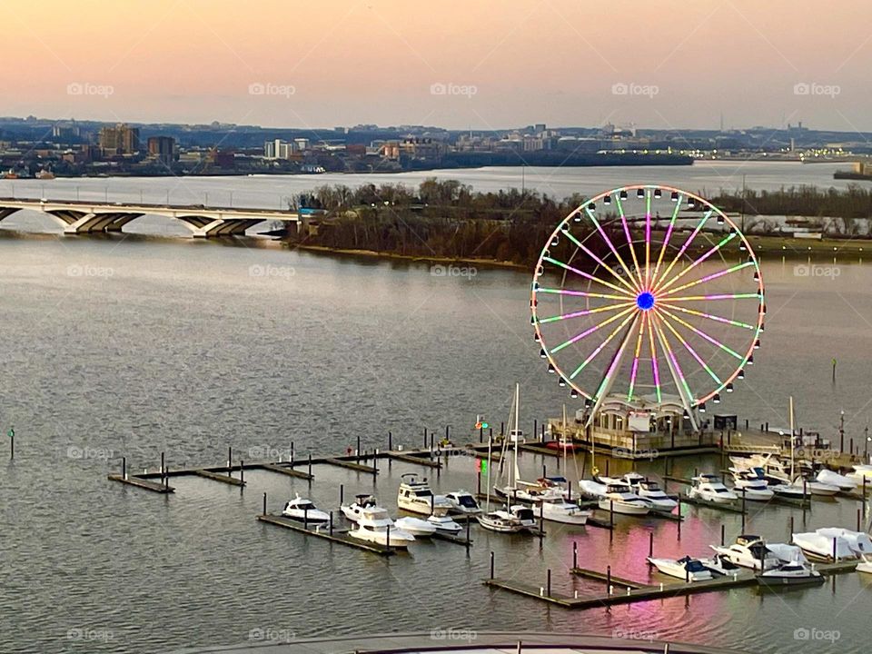National harbor Washington DC at sunset, Ferris wheel, reflection on the bay