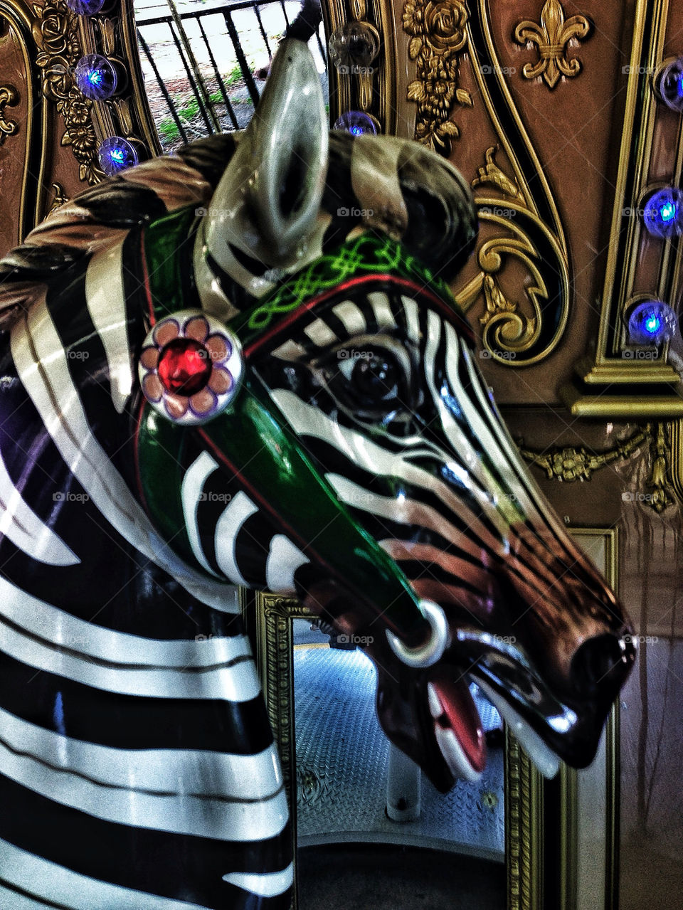 Zebra sculpture to ride in an amusement park carousel