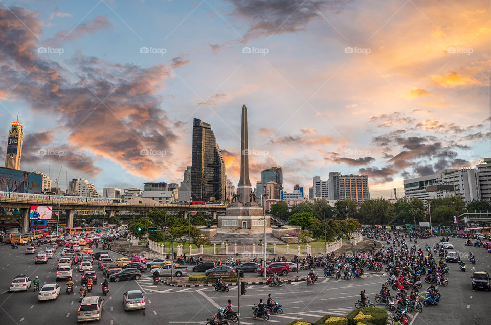 Beautiful sunset scene behind the land mark Victory Monument in Bangkok Thailand