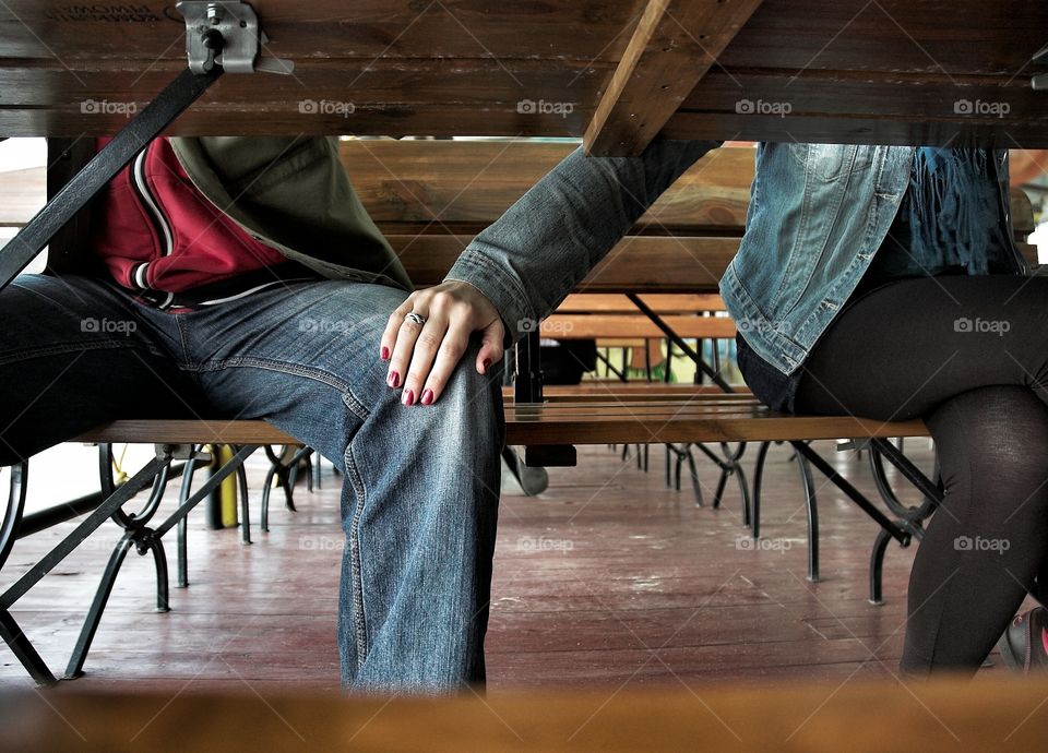 Woman's hand on a man's knee. Woman puts her hand on a man's knee