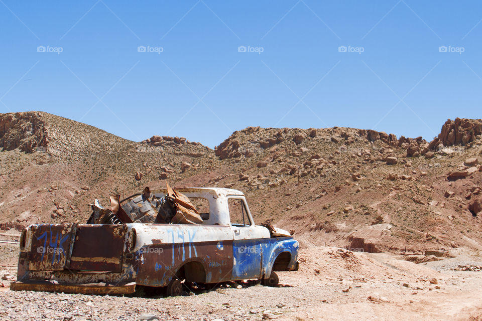 Old and abandoned car in the desert.