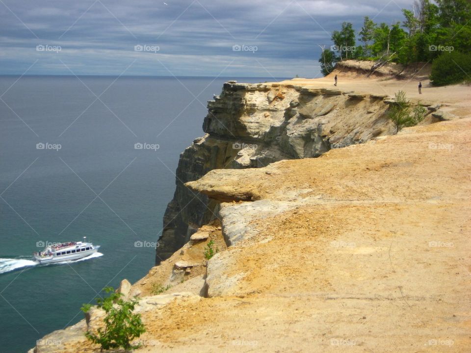 Sandstone Cliffs Overlooking Boat on Lake Superior 