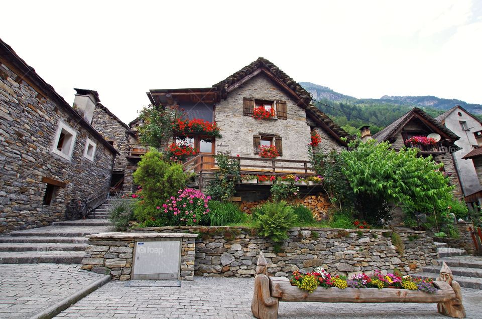 Beautiful countryhouse with flowers at windows, old town in sonogno switzerland.