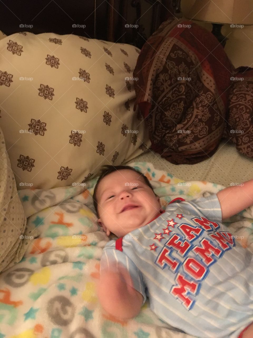 My grandson playing kicking his legs smiling 