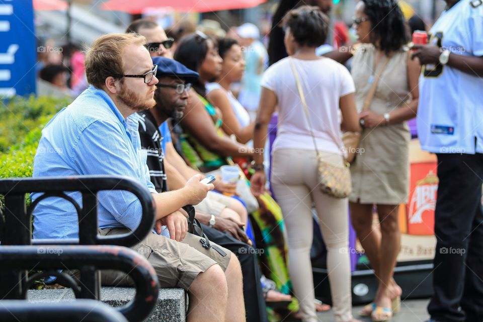 Man sitting in the street chair at the French Quarter festival 