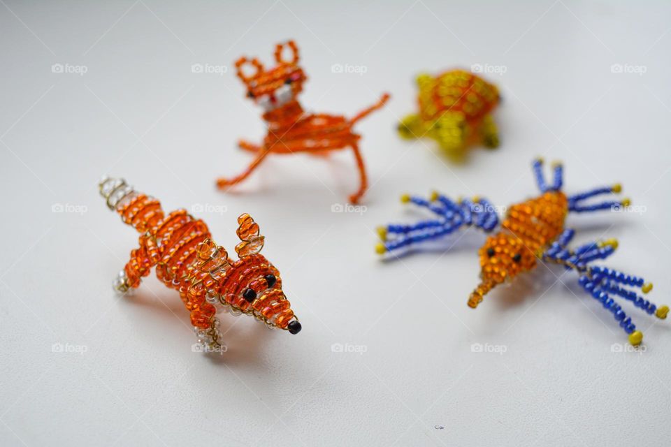 animals figured from beads on a white background, art and craft hobbies