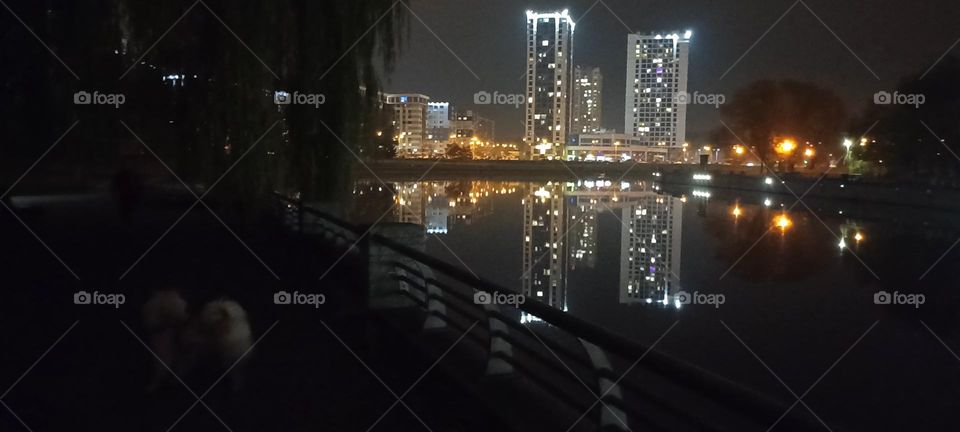 beautiful night light street view, windows magic light, cityscape and reflection in river