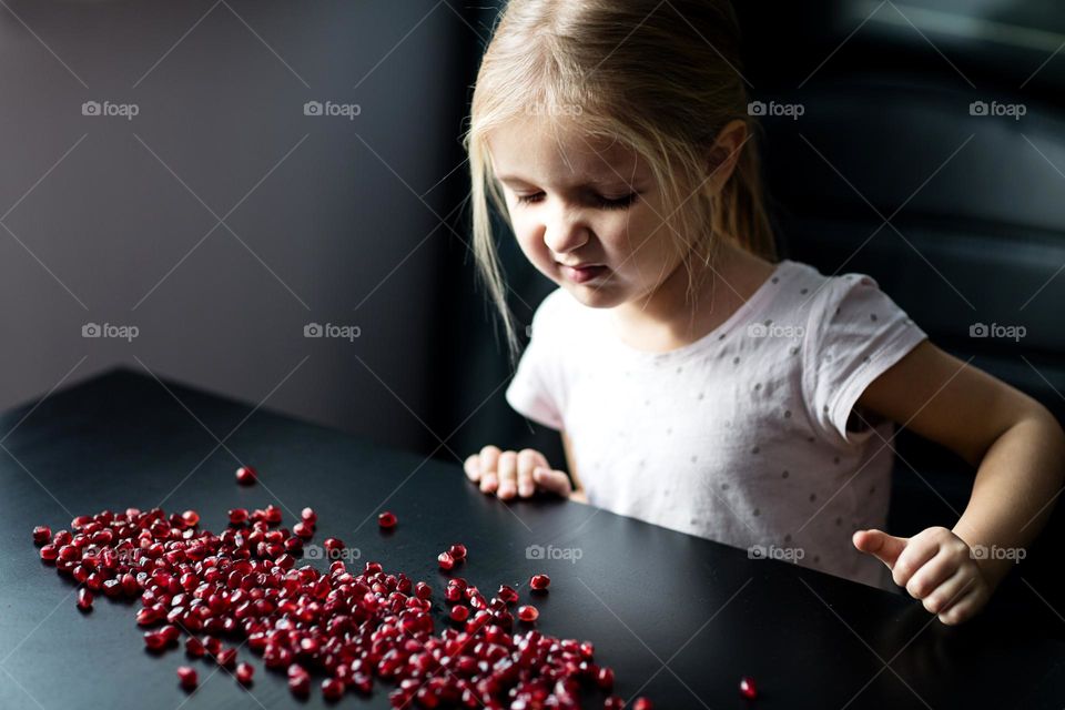 Candid portrait of little Caucasian girl feeling disgust 