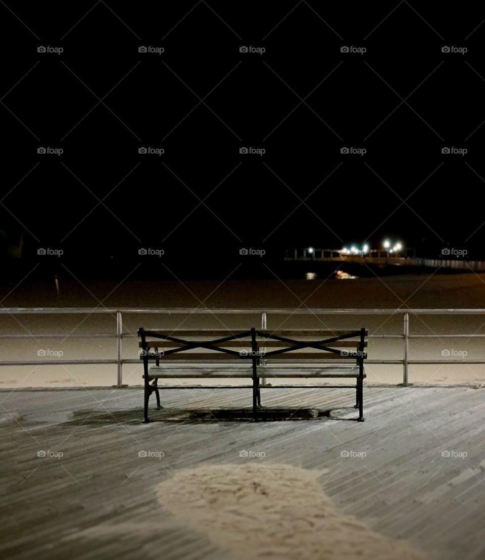 an empty bench at brighton beach in January 