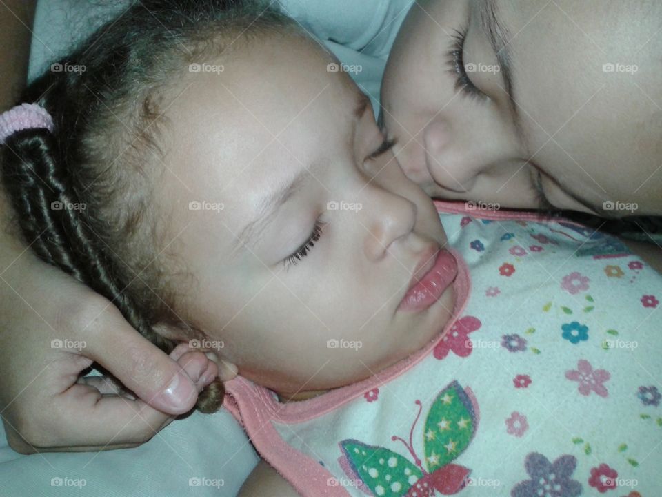 High angle view of girl kissing her sister