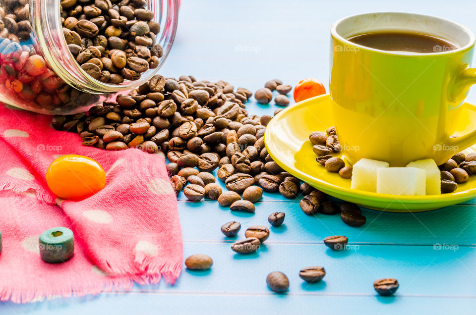 Coffee cup and jar of coffee beans