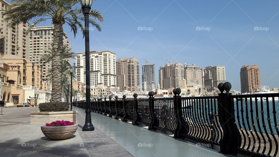Walkway by the ocean/ Surrounded by luxury hotels and apartments