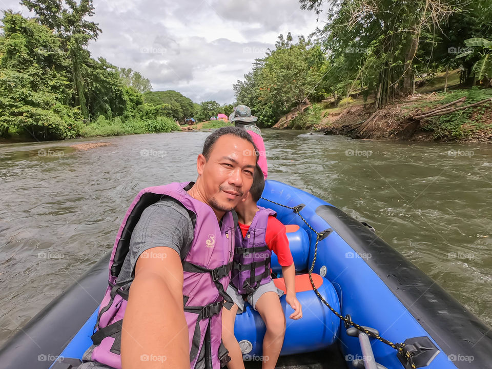 Tourists on the inflatable boat floating on the water in the river The flow of Kaeng Krachan Dam at Phetchaburi in Thailand. June 10, 2019