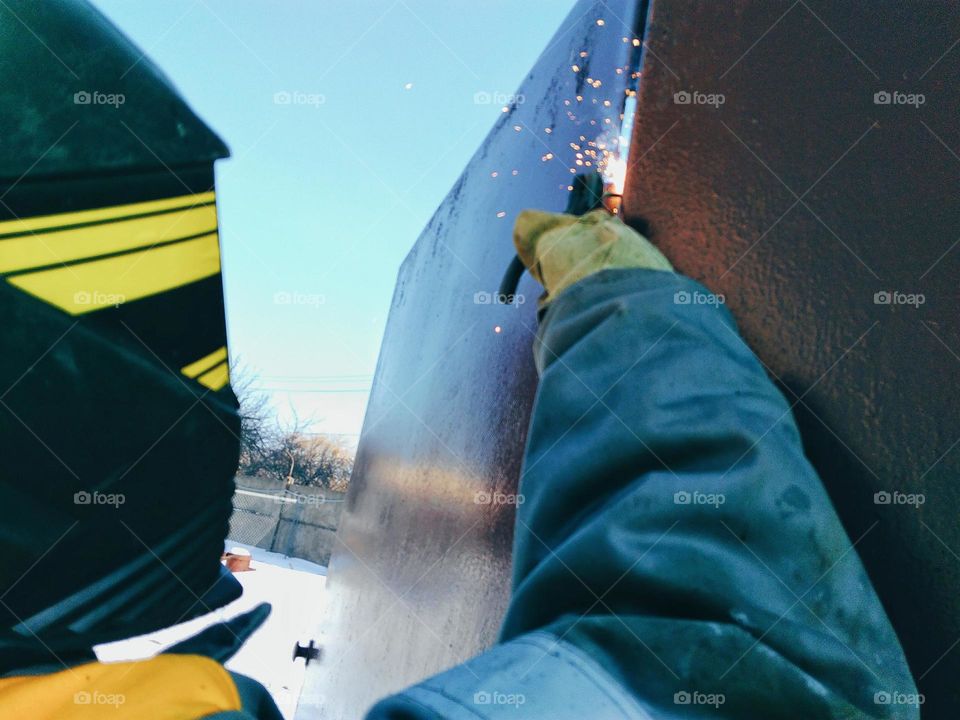 Welder work with metal construction overalls