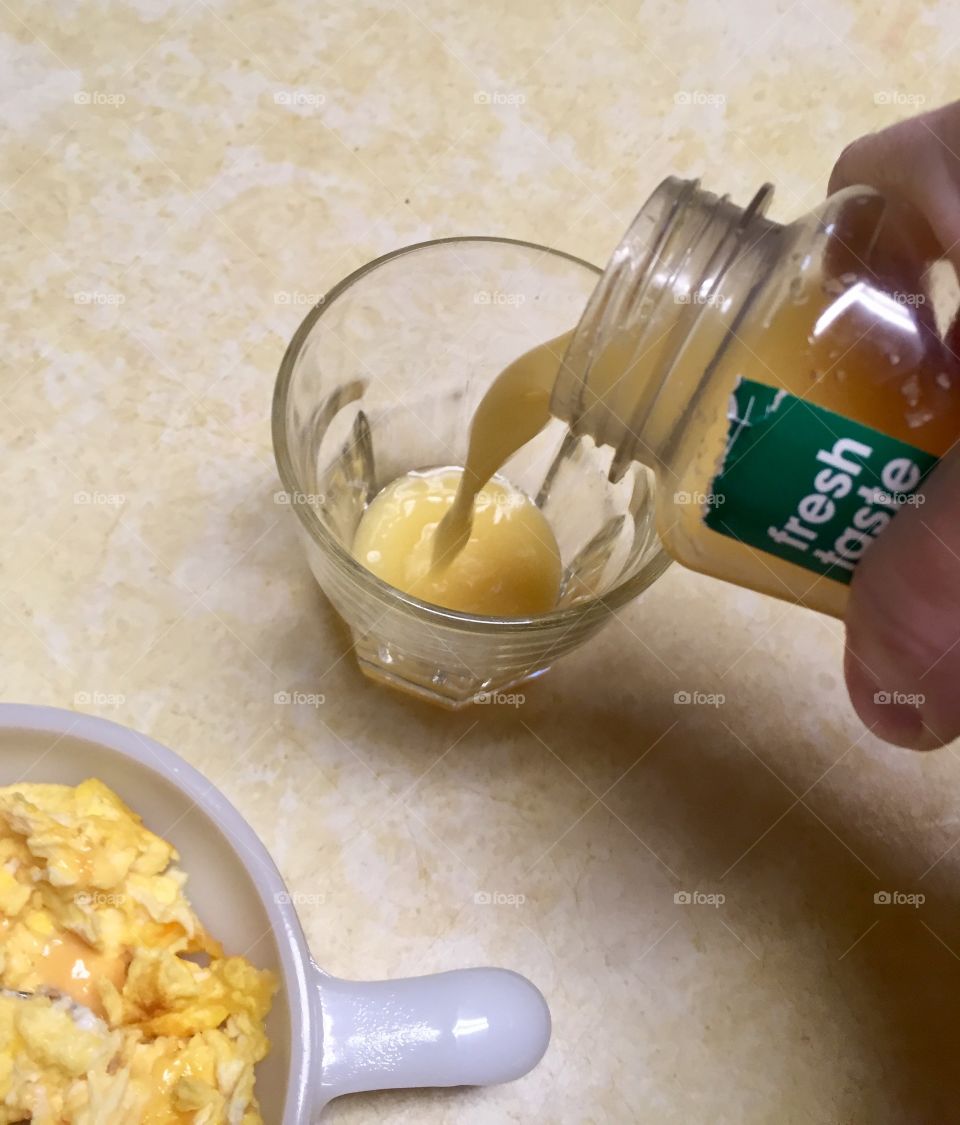 Morning ritual pouring orange juice