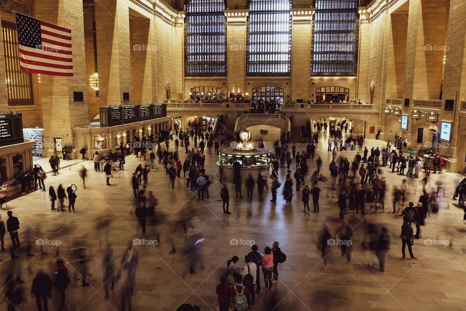 New York City bustling train station, Central Station in New York, moving people in a train station, traveling in New York, long exposure photo, long exposure photography, people waiting at a train station in New York, big and bustling city 