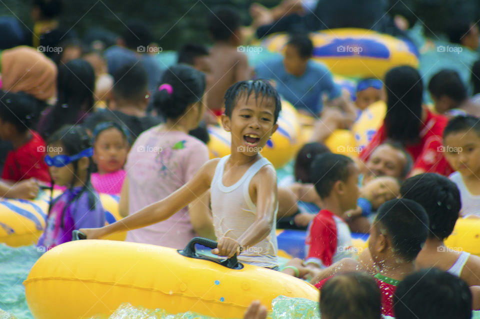 Asian boy enjoying in water park