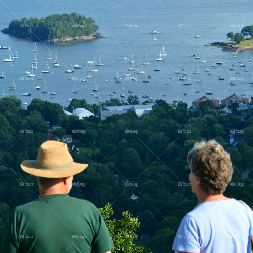 An elderly couple takes a look at sailboats in the Maine coastline! Majestic!