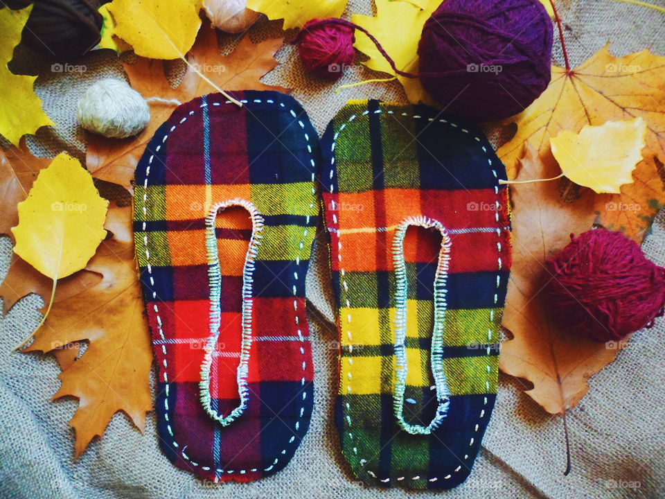 stitched warm slippers and autumn leaves