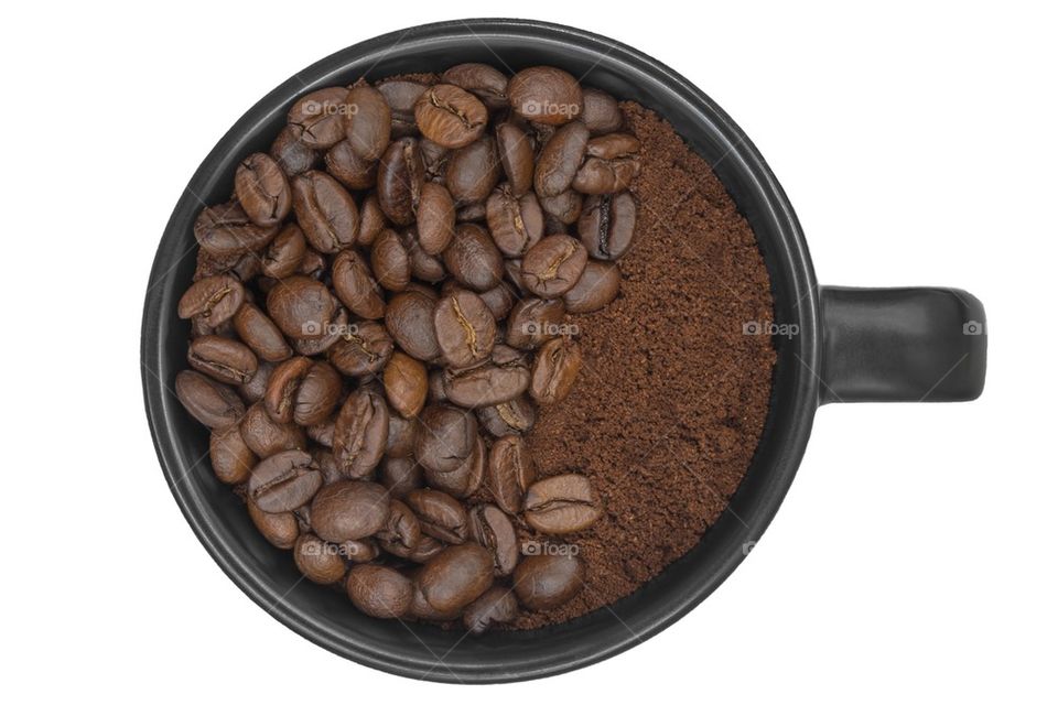 coffeebeans put in the isolated coffee cup on white background.