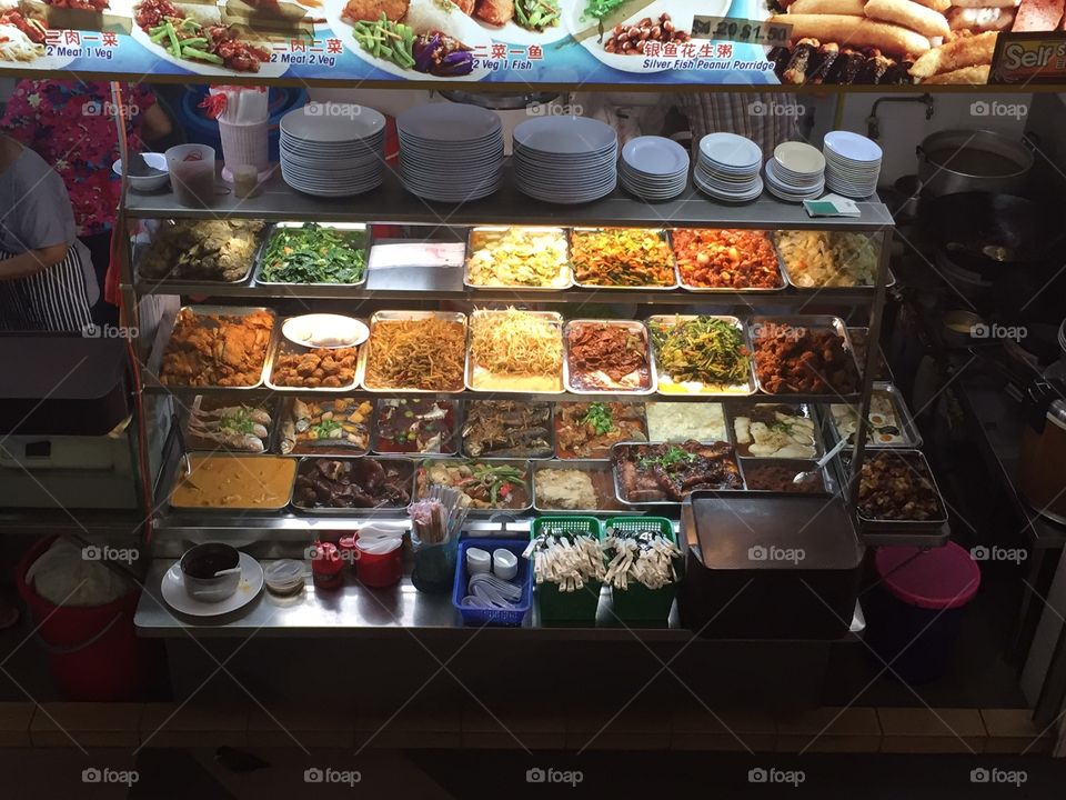 food. variety of local food in a hawker center in Singapore 