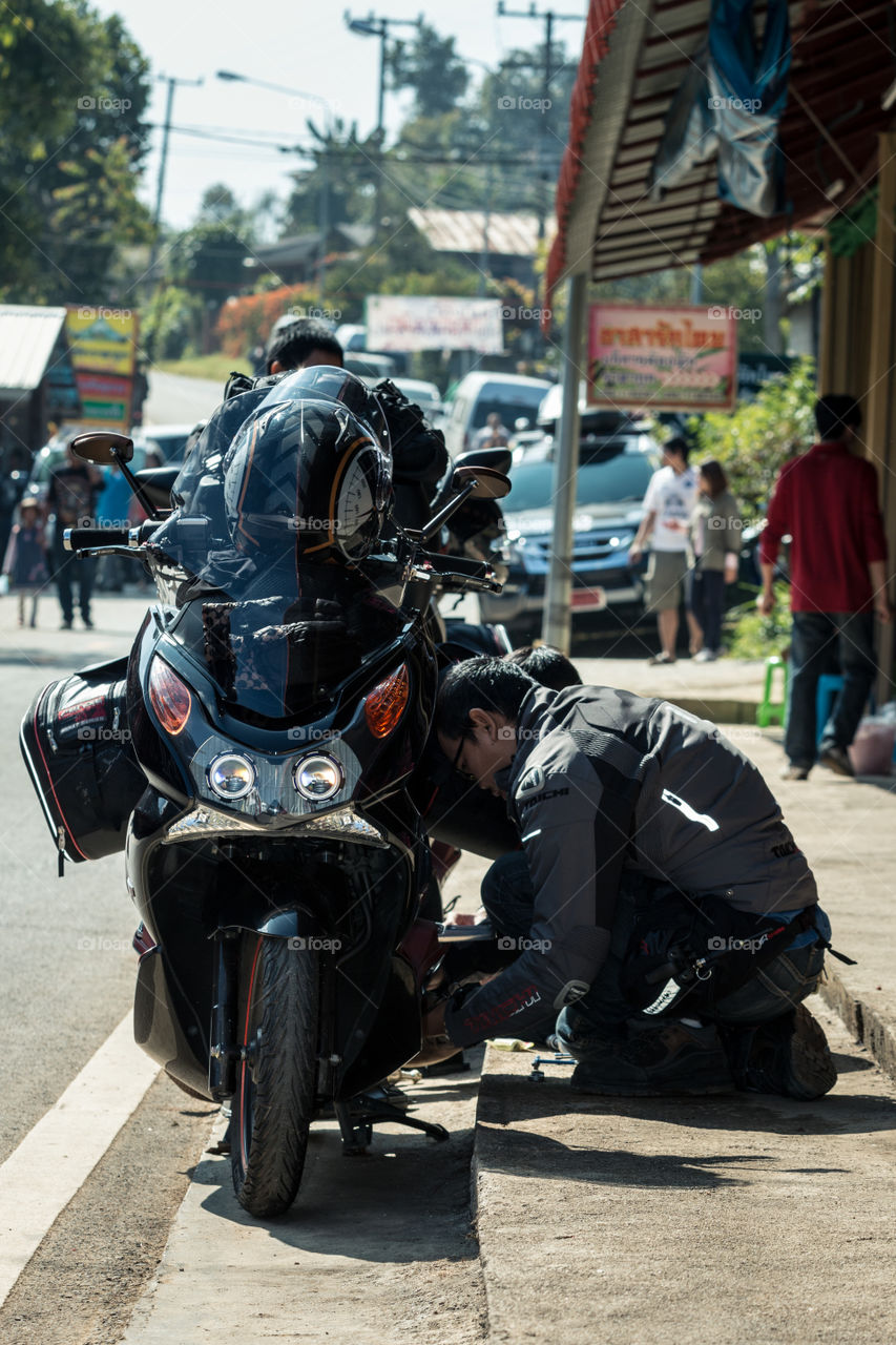 Man fixing a motorcycle 